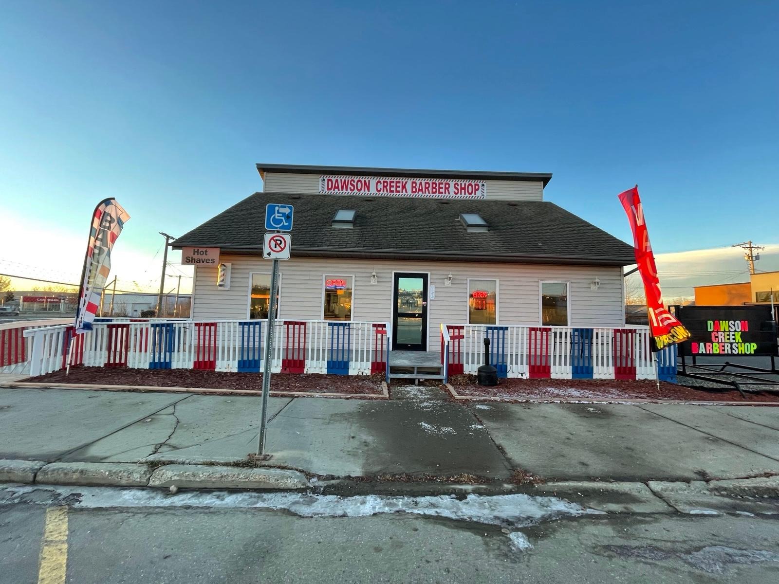 Dawson Creek Barbershop storefront with feather flags — 809 103 Ave