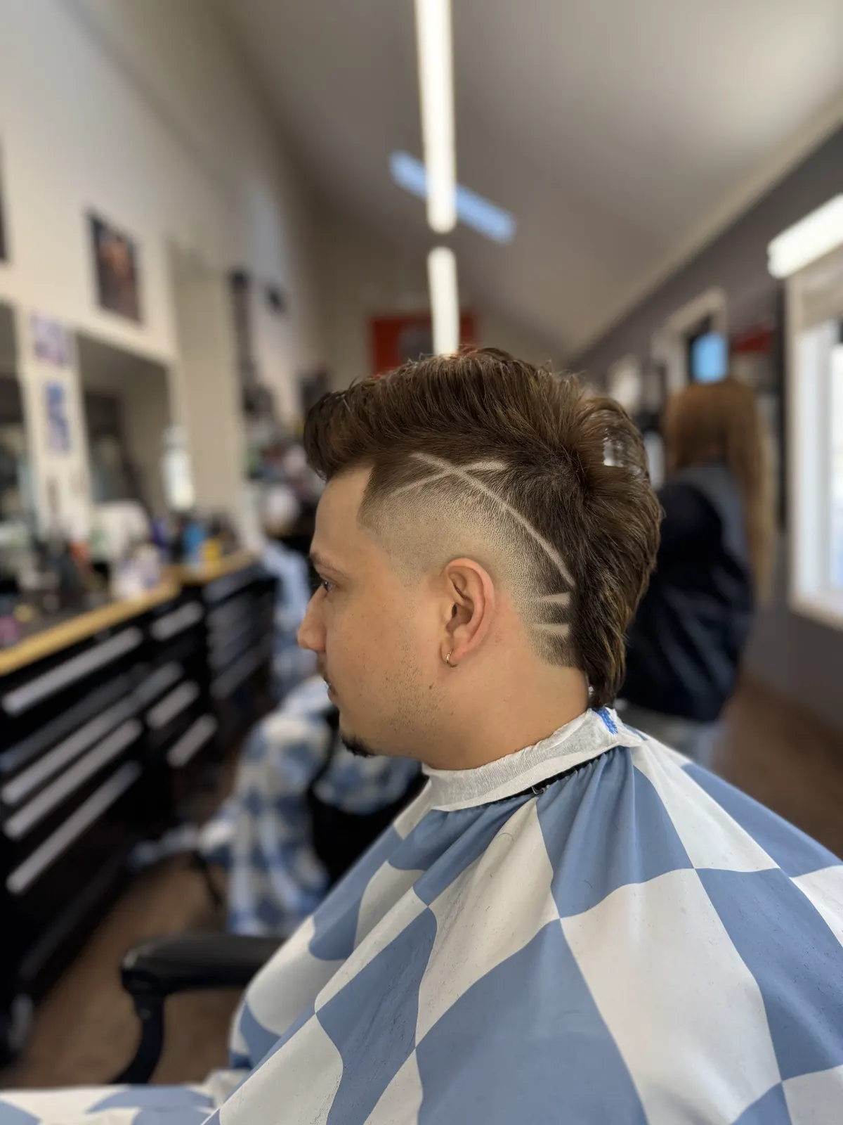 Fade with a design cut at Dawson Creek Barbershop